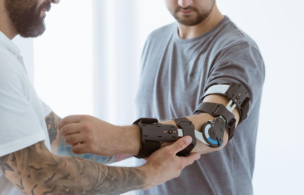 Orthotist Fitting Elbow Brace