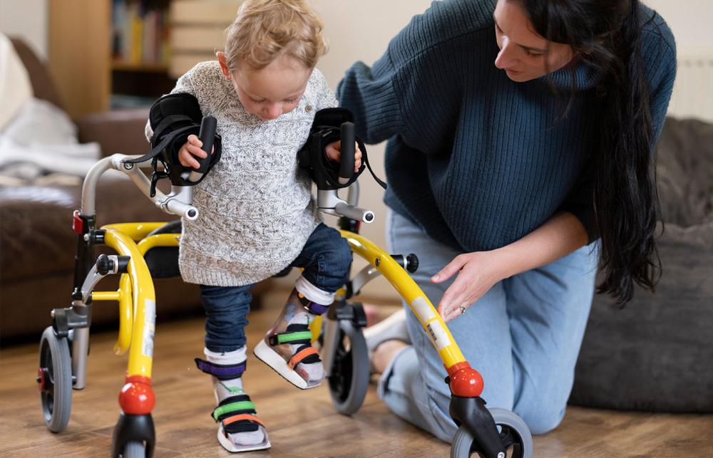 Child learning to walk with orthotics