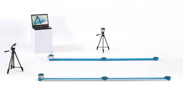 OptoGait system with blue sensor bars, a laptop and camera equipment