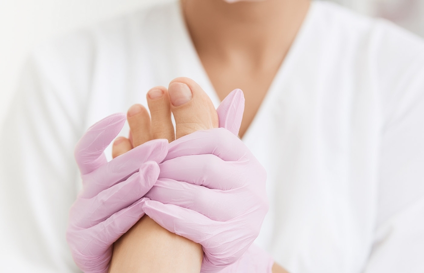 Podiatrist apply foot cream