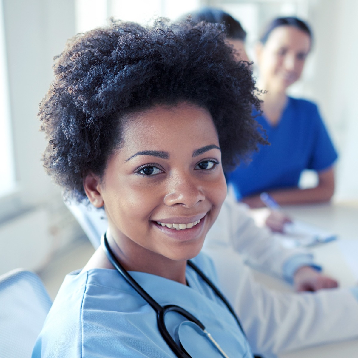 happy-doctor-over-group-of-medics-at-hospital-square
