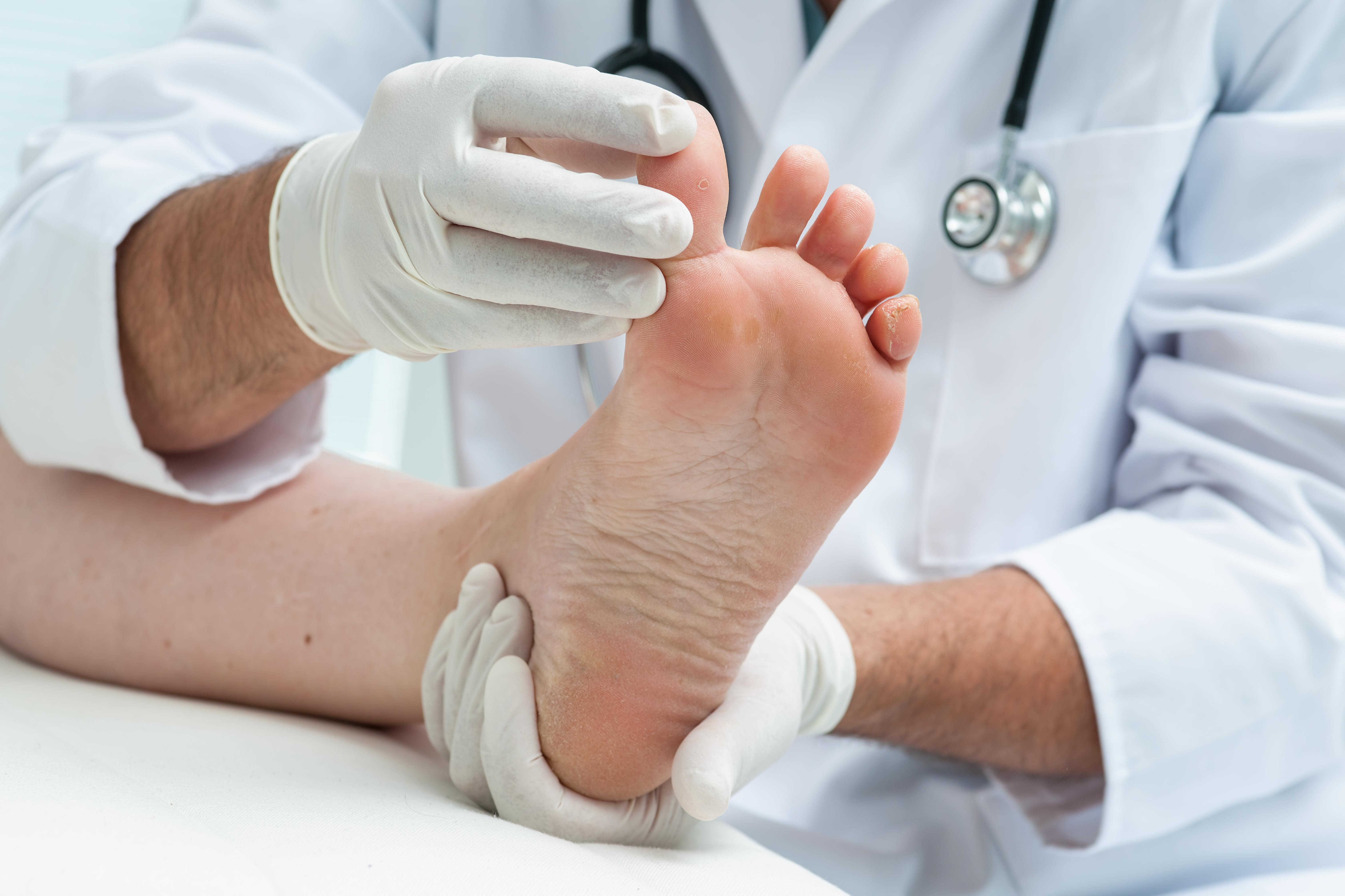 Podiatrist examining patients foot