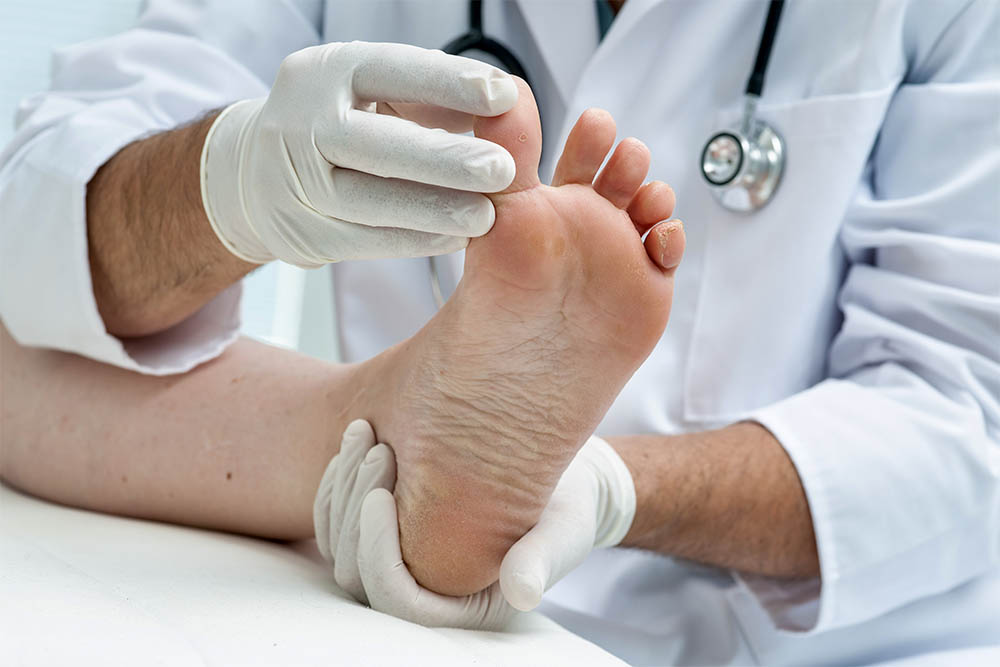 Podiatrist examining patients foot