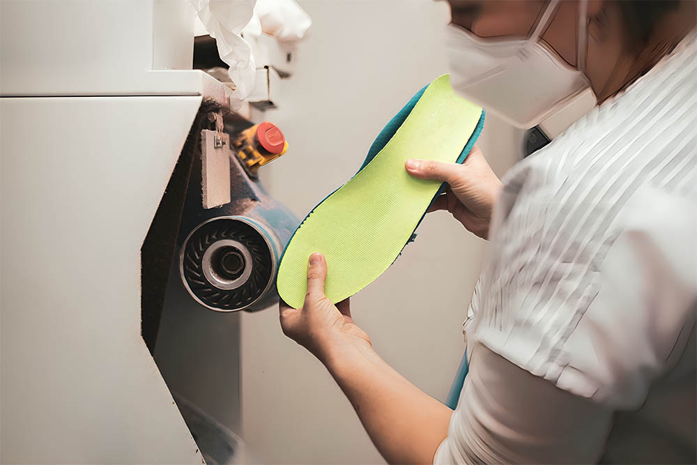 Orthotic being grinded on a grinding machine