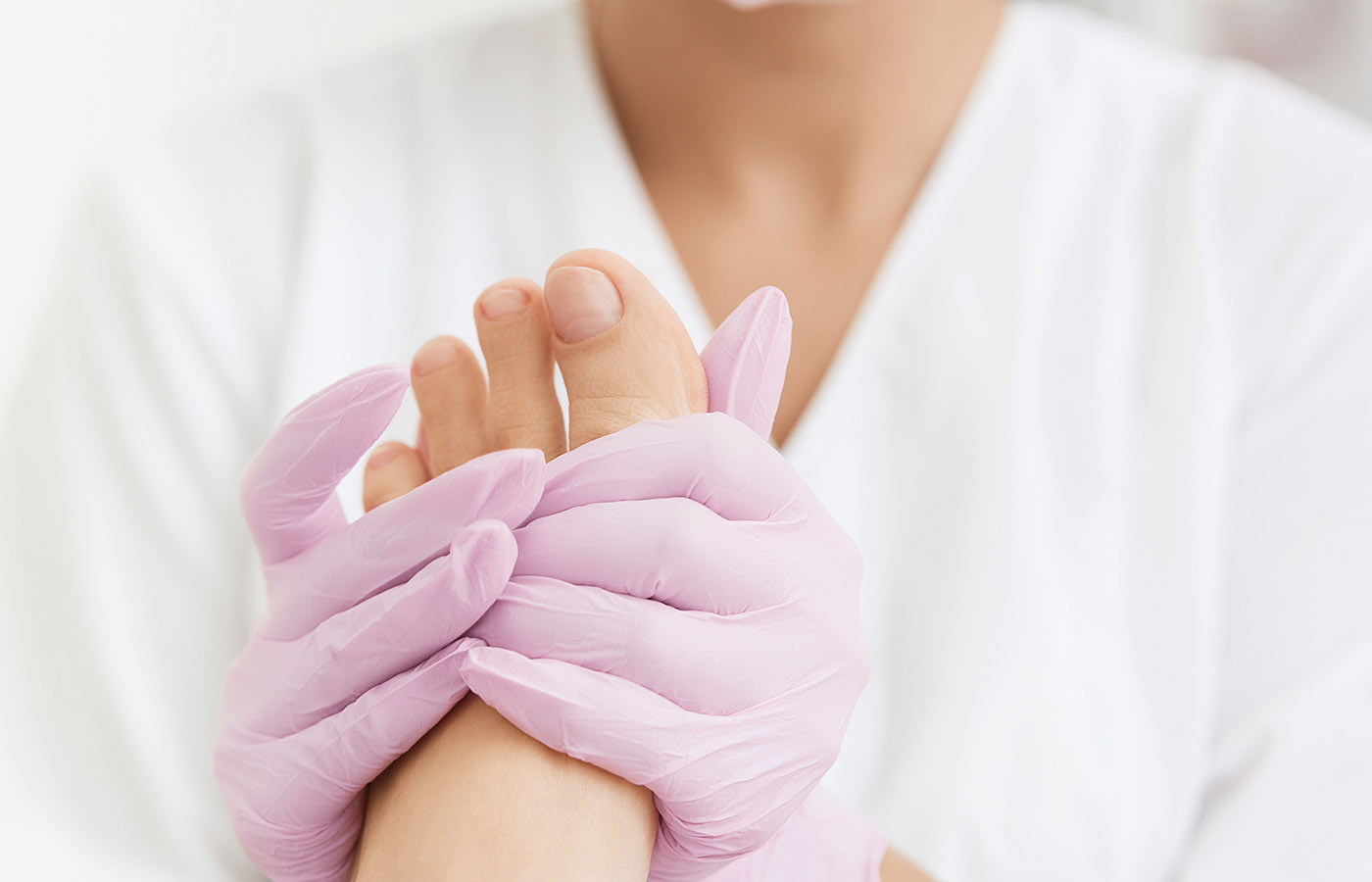Podiatrist apply foot cream